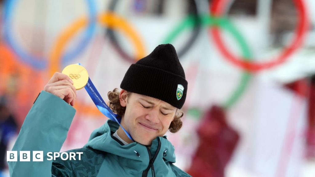 Lucas Pinheiro Braathen holds up his Olympic gold medal