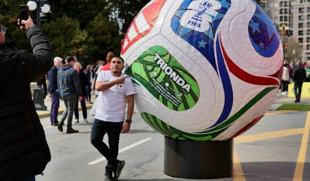A fan snaps a photo alongside a giant soccer ball display outside the B.C. legislature in March. Nelson will host a FIFA event on June 24 at Lakeside Park. (Tony Trozzo/Victoria News)