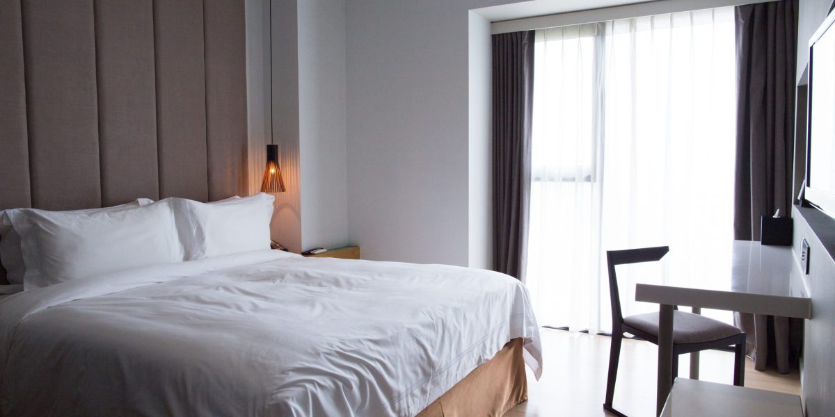 hotel-bedroom-with-double-bed-table-tv-set-scaled.jpg - StiriAlese